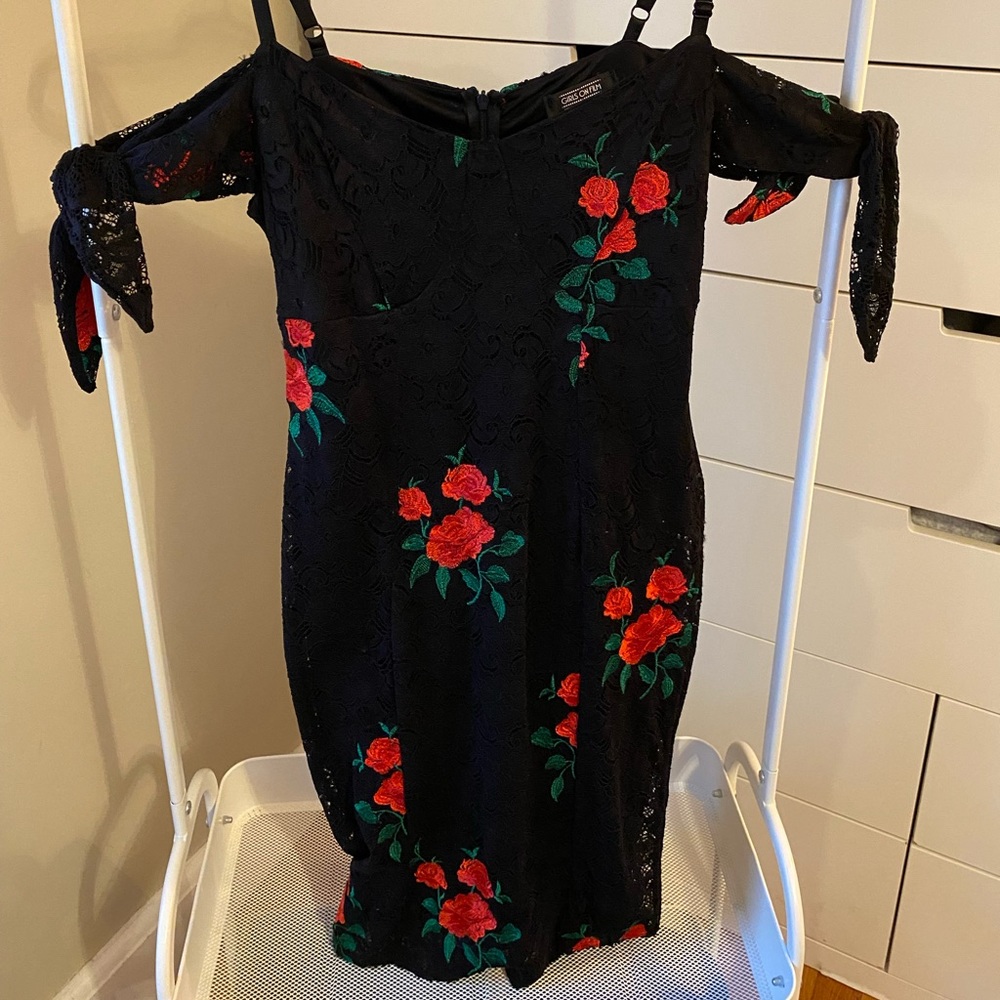 Beautiful black lace body con dress with embroidered rose details.